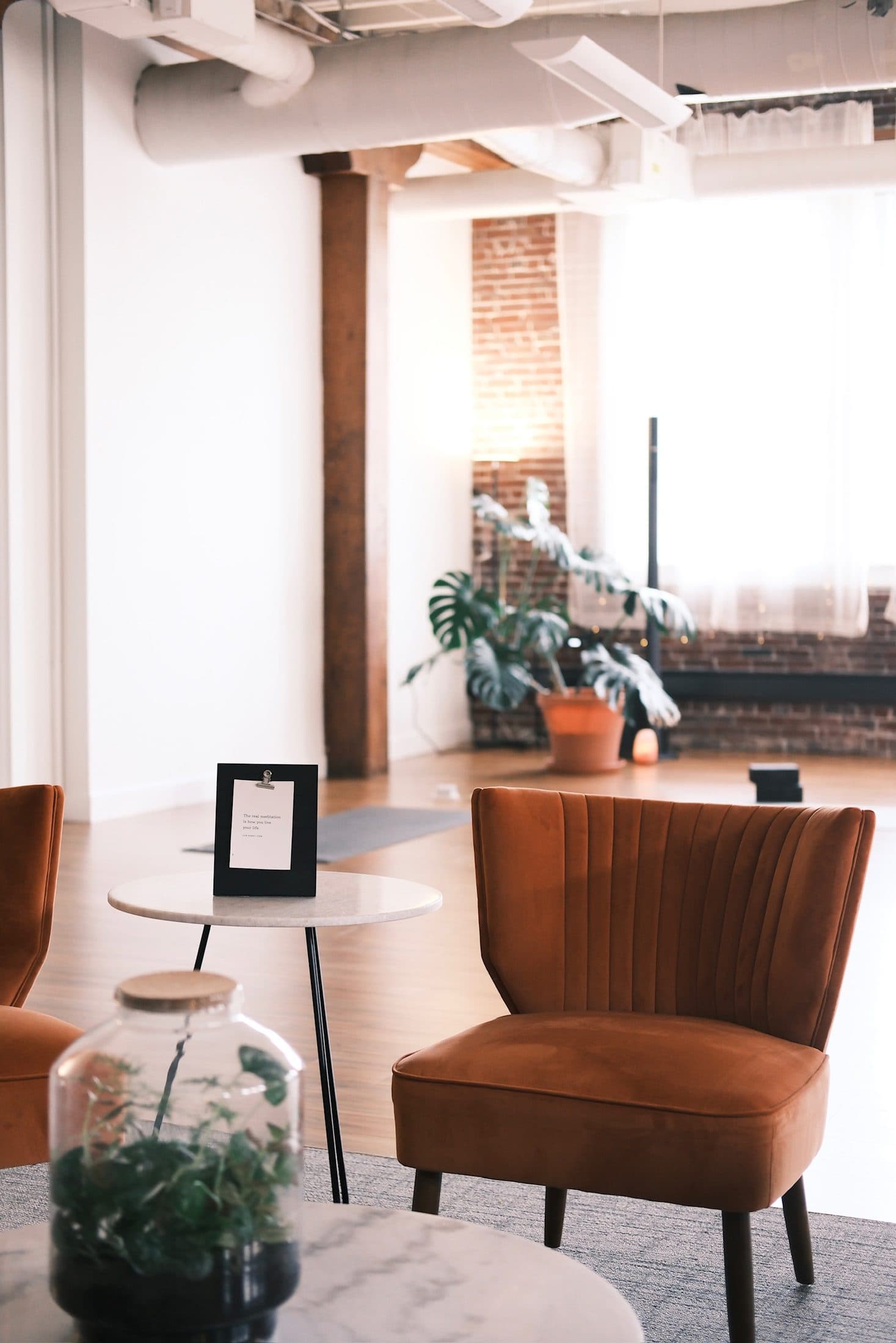 Velvet chairs in the lounge with the studio floor opening up beyond
