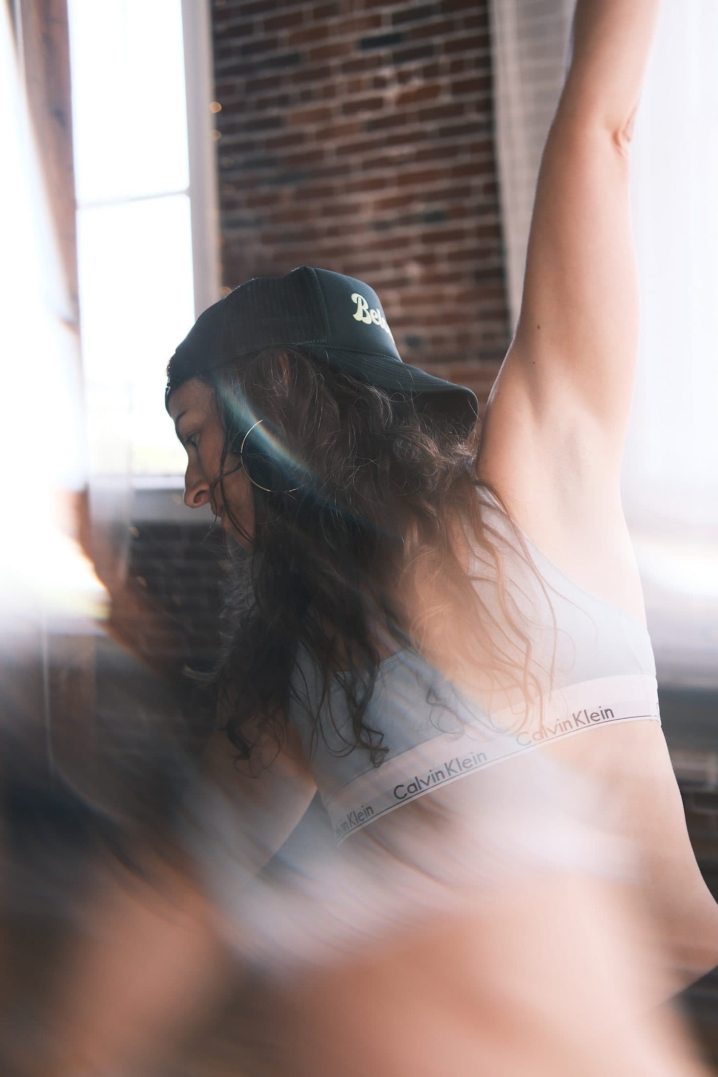 Close long-exposure frame of a practitioner stretching, hair and light in motion